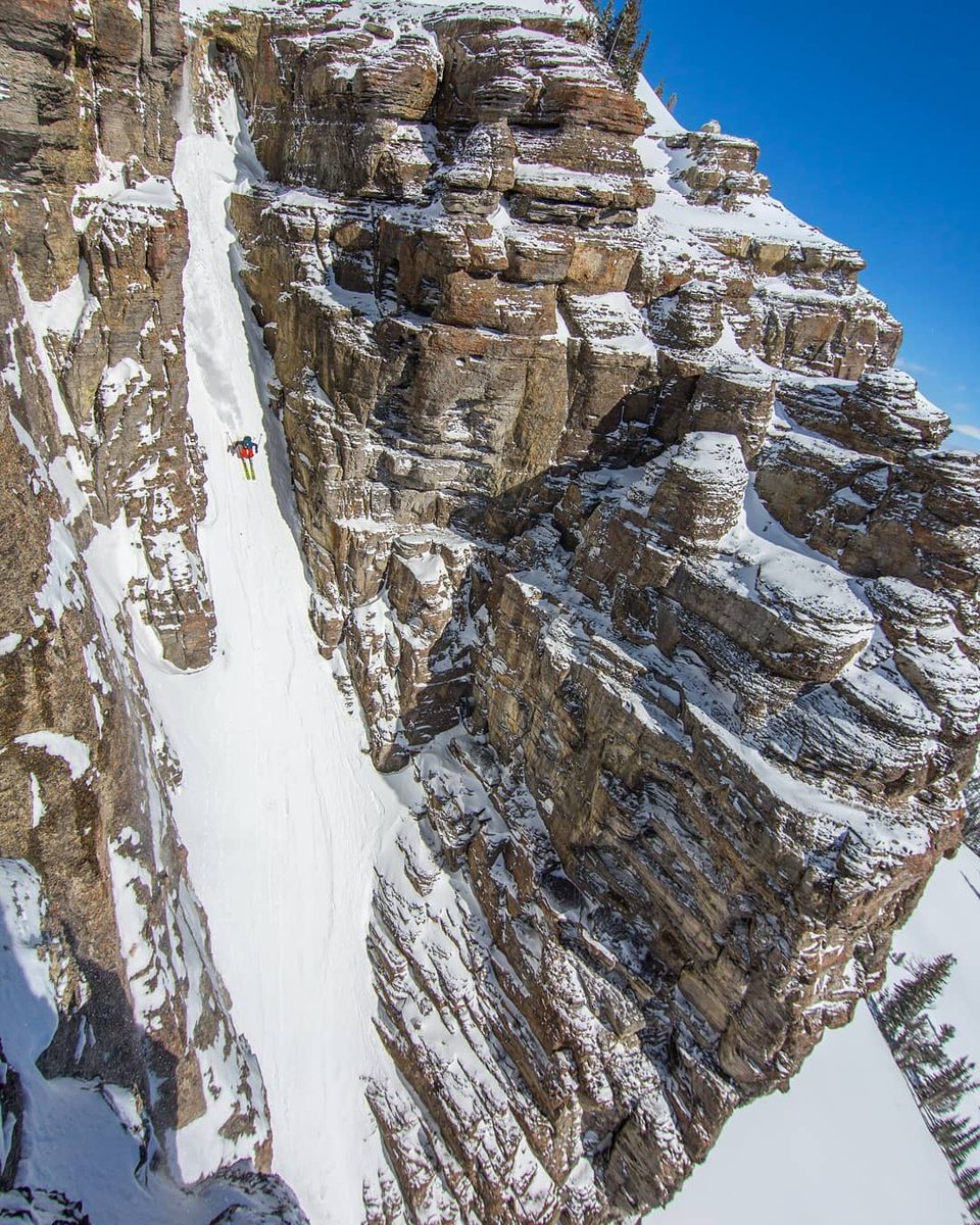SnowBrains founder Miles Clark skiing a steep couloir
